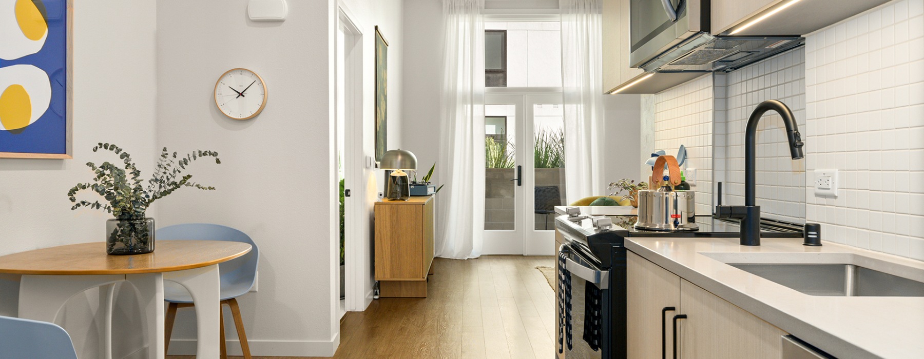 a kitchen with new finishes and a dining area