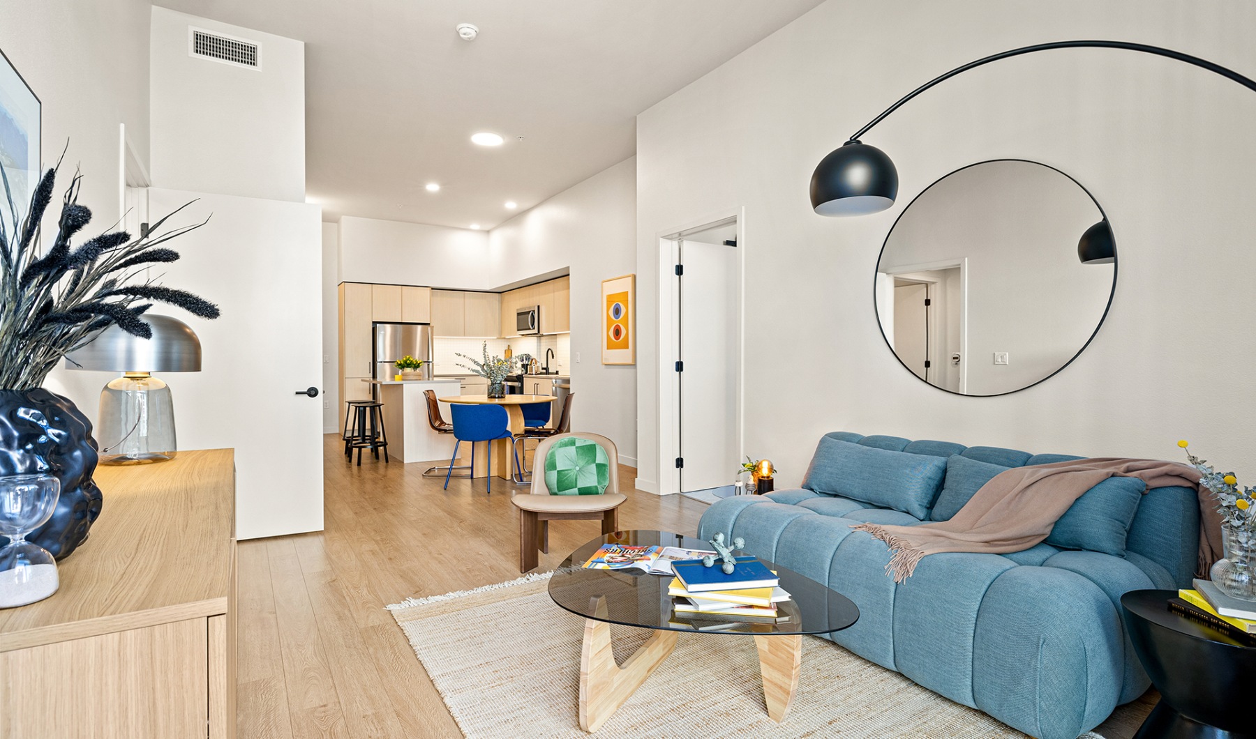 a living room with wood floors and high ceilings