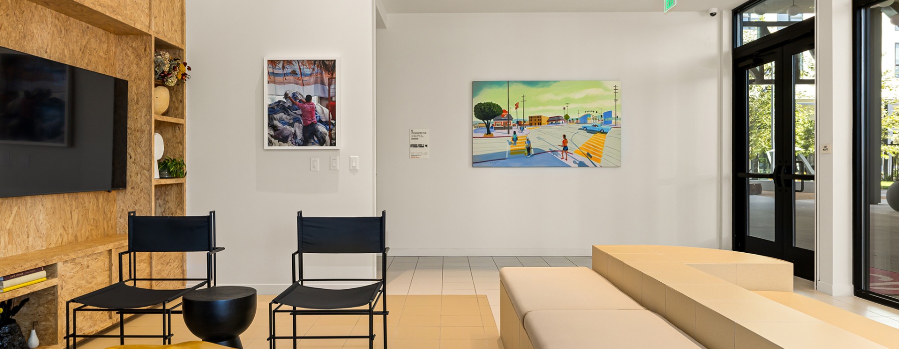 a seating area with a chair and table and tv