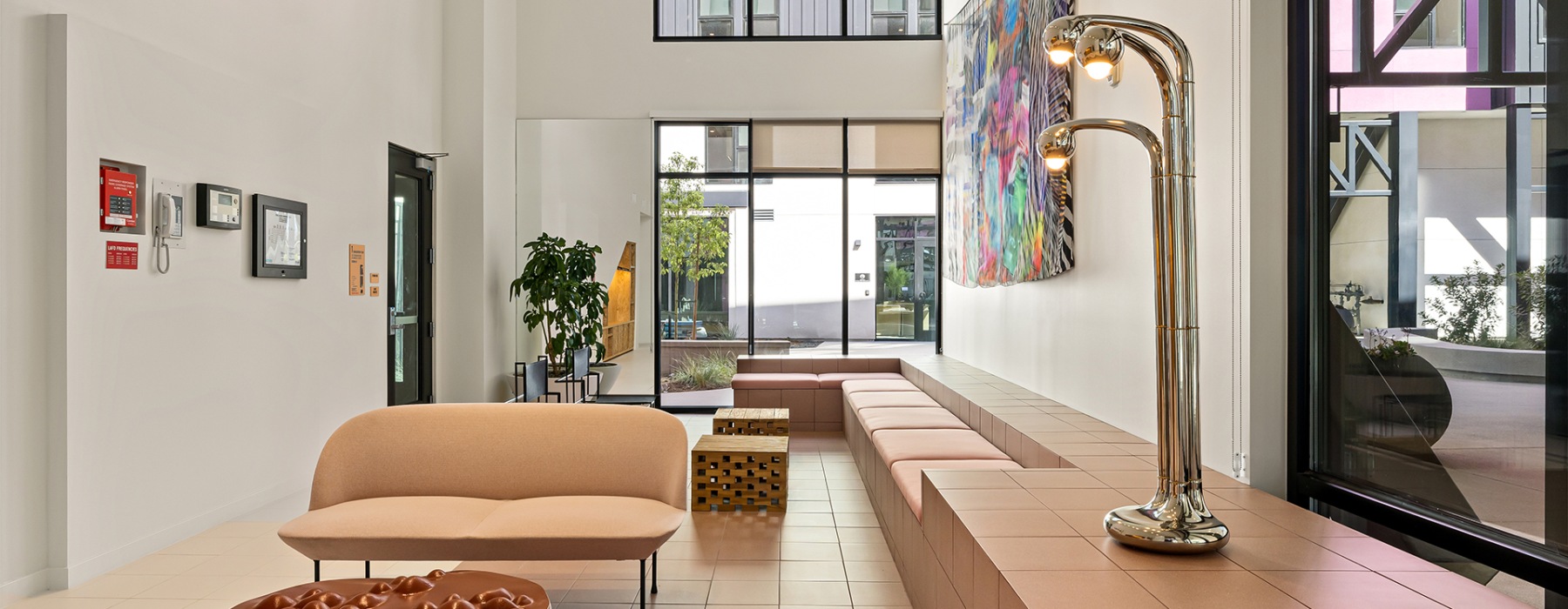 a lounge space with pink couches and seating