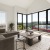 living room with large windows a couch and coffee table